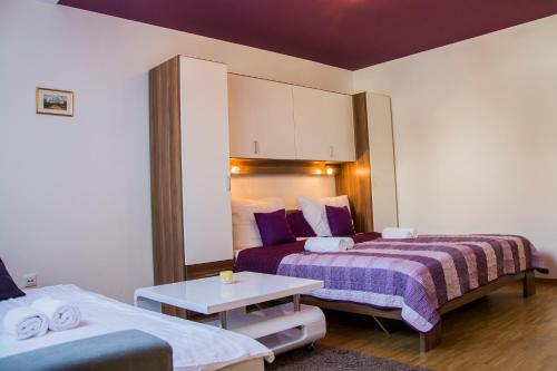 a hotel room with two beds and a table at MTM apartment in Bled