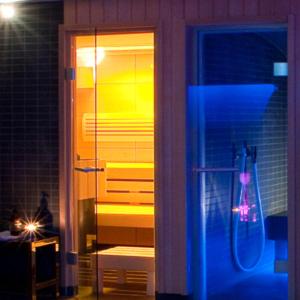 a glass door to a bathroom with a shower at Hôtel Quatorze in Colmar
