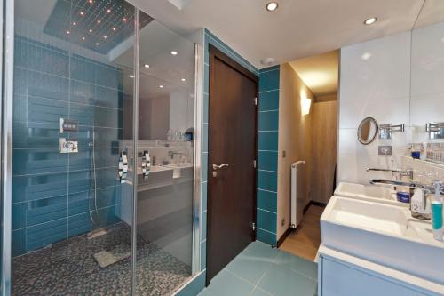 une salle de bain avec douche et lavabo dans l'établissement Névés Appartements VTI, à Val Thorens