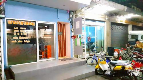 a couple of motorcycles parked outside of a store at Baan Pinklao in Bangkok
