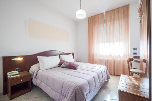 Ένα ή περισσότερα κρεβάτια σε δωμάτιο στο Grifone Hotel Ristorante