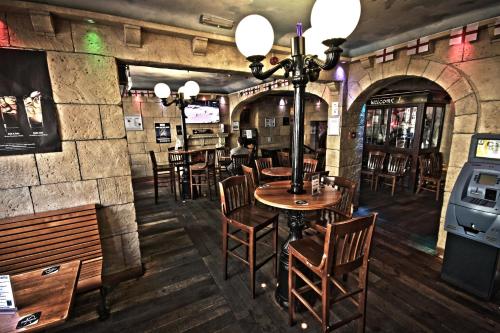 a restaurant with wooden tables and chairs and a bar at The George Hotel in Whitby