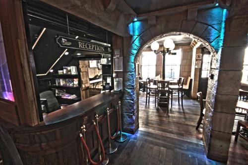 a restaurant with a bar and a dining room at The George Hotel in Whitby