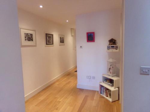 an empty room with a hallway with paintings on the walls at RossNua in Rosscarbery
