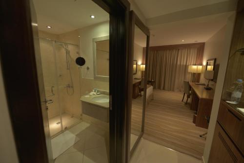 a bathroom with a shower and a sink at Nawaress Hotel in Jazan
