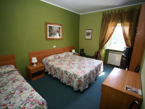Ένα ή περισσότερα κρεβάτια σε δωμάτιο στο Hotel Sutrium