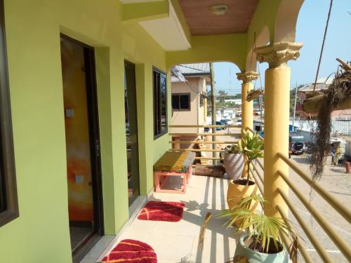 a balcony of a house with green walls at Feehi's Place in Accra