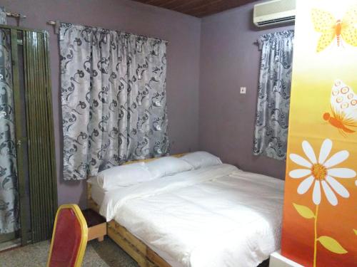 a small bedroom with a bed and a window at Feehi's Place in Accra