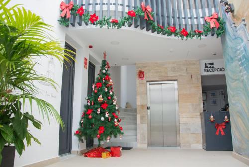 a christmas tree in the middle of a building at La Pasajera Hostal Boutique in Conil de la Frontera