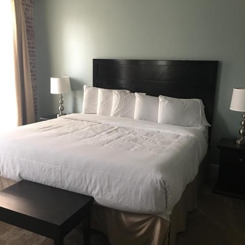 a bedroom with a large bed with white sheets and pillows at Talbott Tavern and Inn in Bardstown