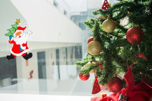 a christmas tree with decorations on it in a building at La Pasajera Hostal Boutique in Conil de la Frontera