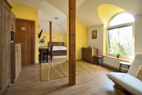 a living room with a bed and a window at penzion LILIE in Litomyšl