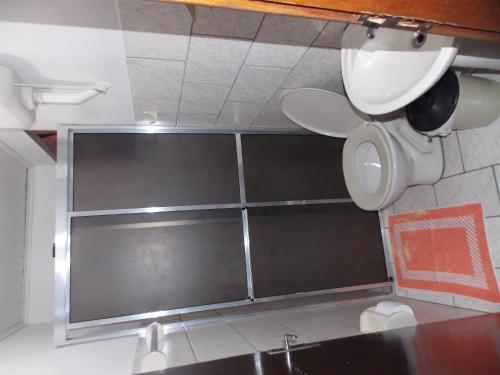 a bathroom with a sink and a toilet in a room at Pousada Paraíso in Ilha do Mel