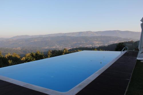 a swimming pool on the roof of a house at Paço da Torre de Figueiredo das Donas in Figueiredo das Donas