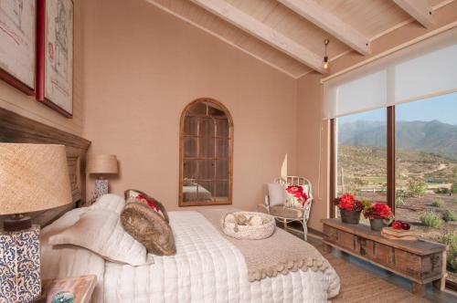 a bedroom with a bed and a large window at Villas Toscanas in Limache