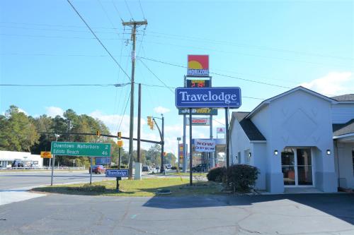 a sign for a travelodge restaurant on the corner of a street at Travelodge by Wyndham Walterboro in Walterboro