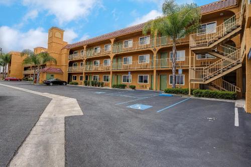 an empty parking lot in front of a building at Buena Vista Inn in Anaheim