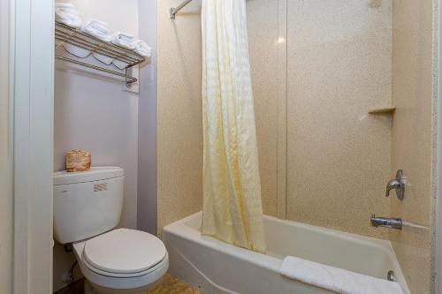 a bathroom with a toilet and a shower at Buena Vista Inn in Anaheim