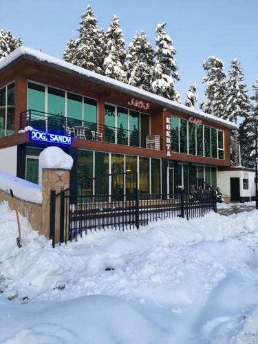 a building with snow in front of it at Chalet Kokhta in Bakuriani