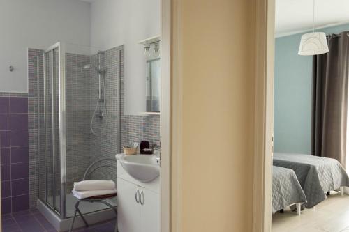 un baño con lavabo y ducha en Bosco Sea Apartments, en San Leone