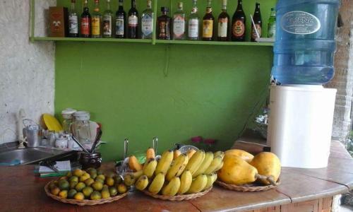 two baskets of fruit on a counter next to a sink at Guanna's Place Room and Resto Bar in Malapascua Island