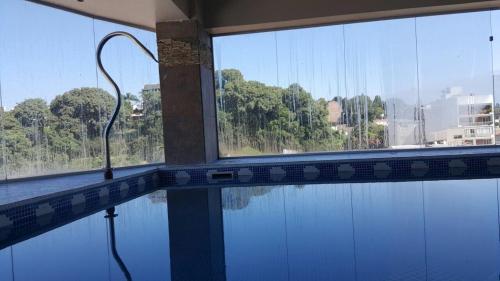 a swimming pool with a view of the water at Ohasis Hotel Jujuy & Spa in San Salvador de Jujuy