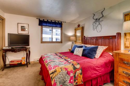 a bedroom with a bed and a flat screen tv at The Plaza Condominiums by Crested Butte Mountain Resort in Mount Crested Butte