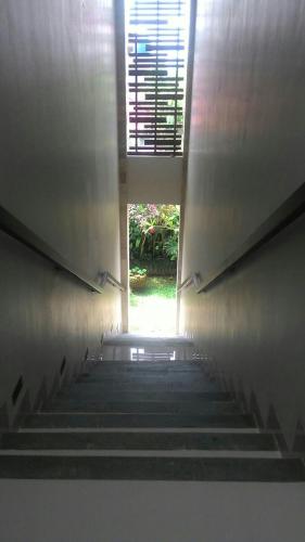 a staircase leading up to a building with a window at ThreeWin Homestay in Ubud