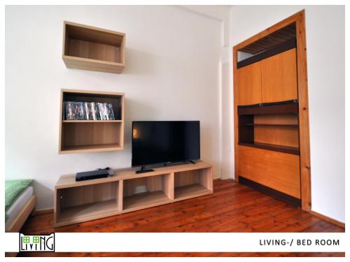 a living room with a flat screen tv on a wall at ACO Living - A Cheap Overnight in Klagenfurt