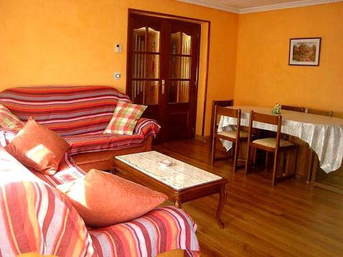 a living room with a couch and a table at La Loma in Boñar