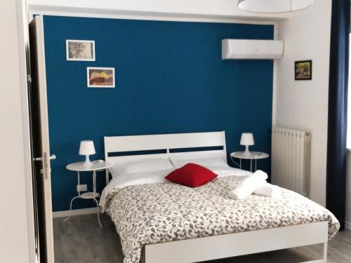 a bedroom with a blue wall and a bed at Nonna Francesca in Patti