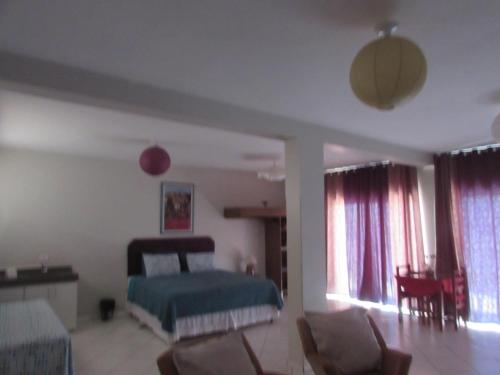 a living room with a bed and a couch at Pousada Beira Rio in Itumbiara