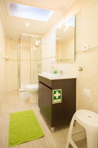 a bathroom with a sink and a toilet and a mirror at CASAL RIQUEZO T2 - Serra da Pescaria - NAZARÉ in Nazaré