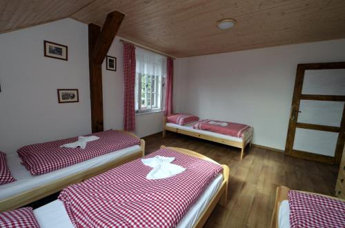 a room with two beds and a window at Hospoda U Lípy in Ostrov