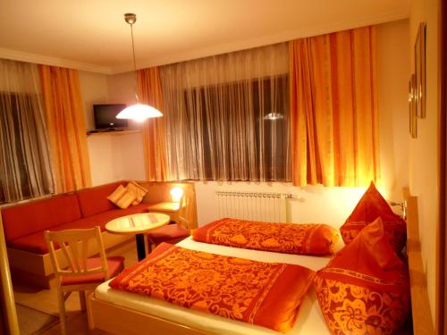 a hotel room with a bed and a living room at Haus Traninger in Flachau