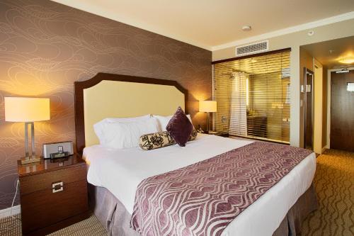 a hotel room with a large bed and two lamps at Pinnacle Hotel at the Pier in North Vancouver