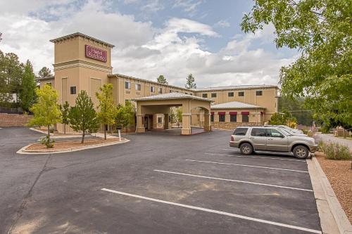 a car parked in a parking lot in front of a hotel at Hotel Ruidoso in Ruidoso