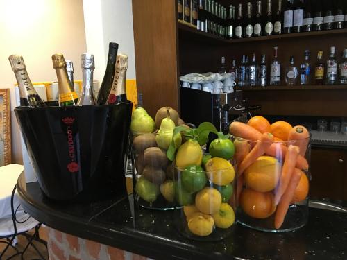 a bunch of fruit and vegetables on a counter at Hotel Don Carlo in Broni