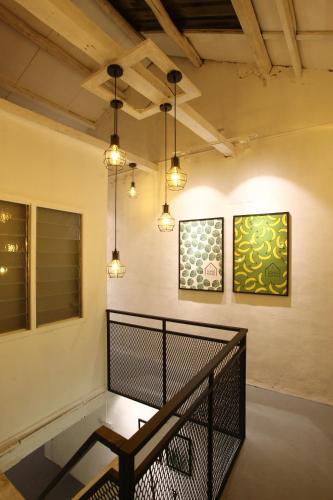 a room with a table and two paintings on the wall at Stay SongSong Beach Street in George Town
