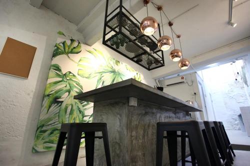 a kitchen with two black chairs and a stove at Stay SongSong Beach Street in George Town
