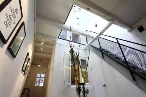 a staircase in a building with a large window at Stay SongSong Beach Street in George Town