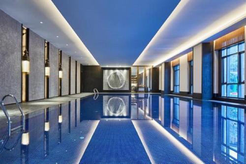 a pool in a building with a swimming pool at Wanda Realm Resort Nanning in Nanning