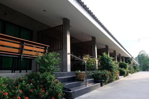 a building with stairs and potted plants on it at Nam Sai Loft Resort in Chao Lao Beach