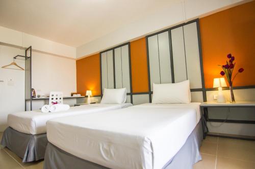 Regent Ngamwongwan Hotelにあるベッド