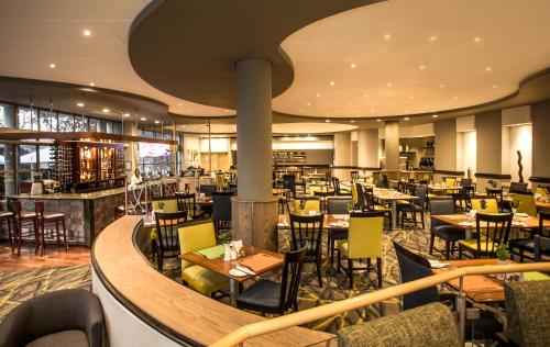 a restaurant with tables and chairs in a building at Garden Court Eastgate in Johannesburg