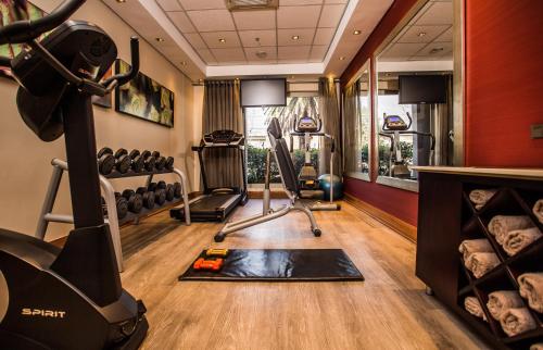 a gym with a treadmill and exercise equipment at Garden Court Eastgate in Johannesburg