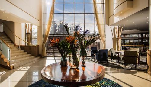 a lobby with a table with plants on it at Garden Court Eastgate in Johannesburg