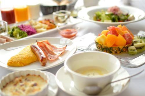 a table with plates of food and a cup of coffee at Amakusa Tenku No Fune in Kami Amakusa