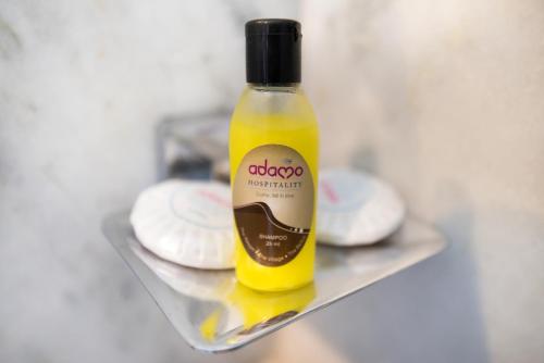 a bottle of oil sitting on a shelf with cookies at Hotel Sanmukh By Adamo in Nāthdwāra