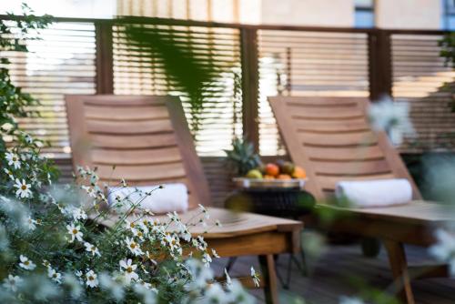 two chairs and a table with fruit on a patio at Leonardo Boutique Jerusalem in Jerusalem